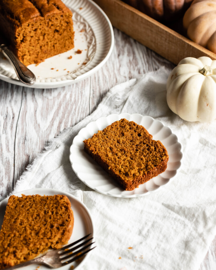 Slice of pumpkin bread on plate with fluted edges