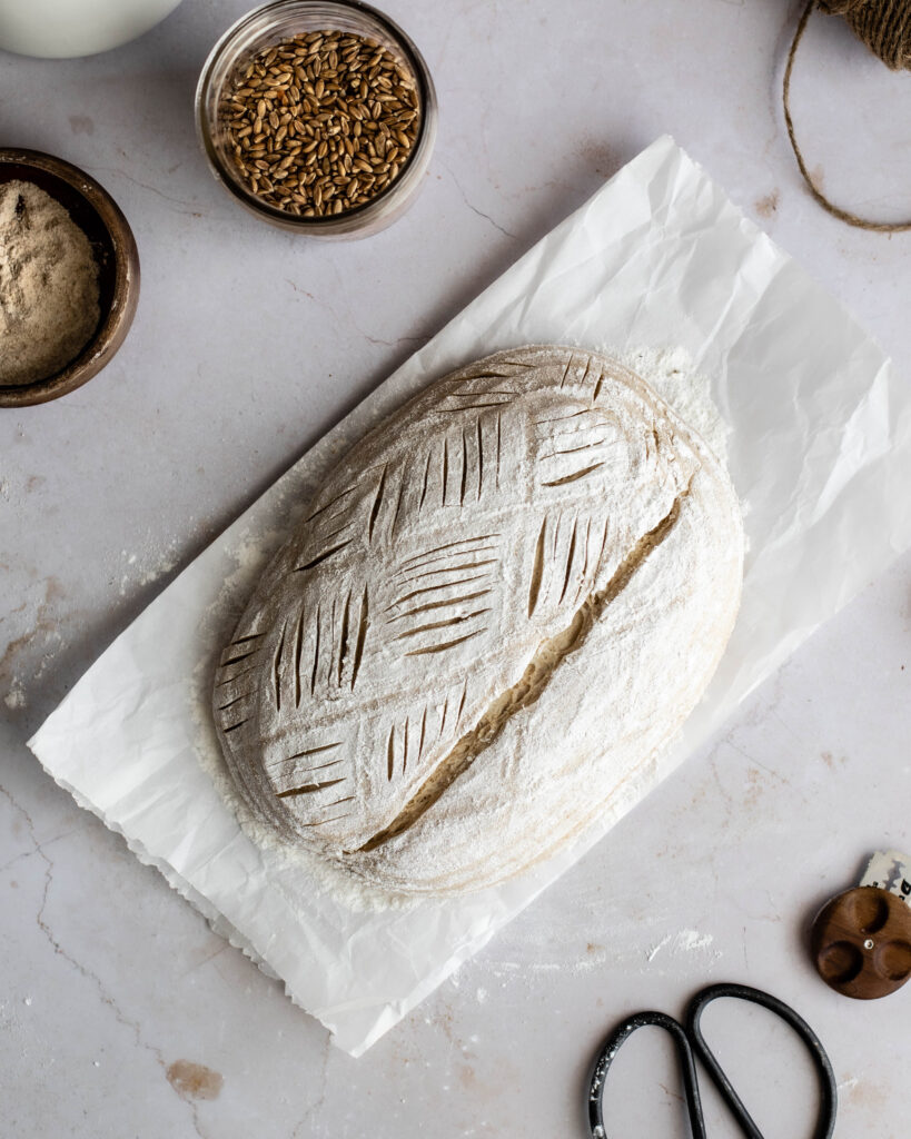dough scored with a decorative basket weave pattern