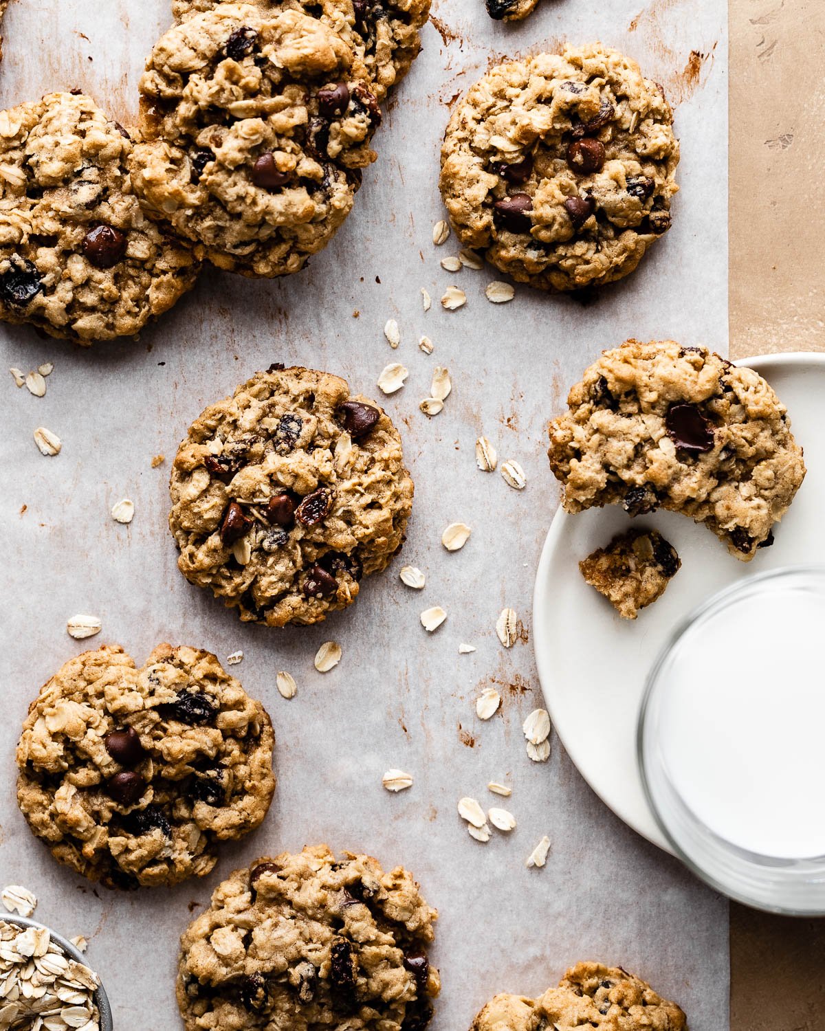 Oatmeal chocolate chip cookies on a piece of parchment paper. 