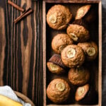 pile of banana muffins in a wood box