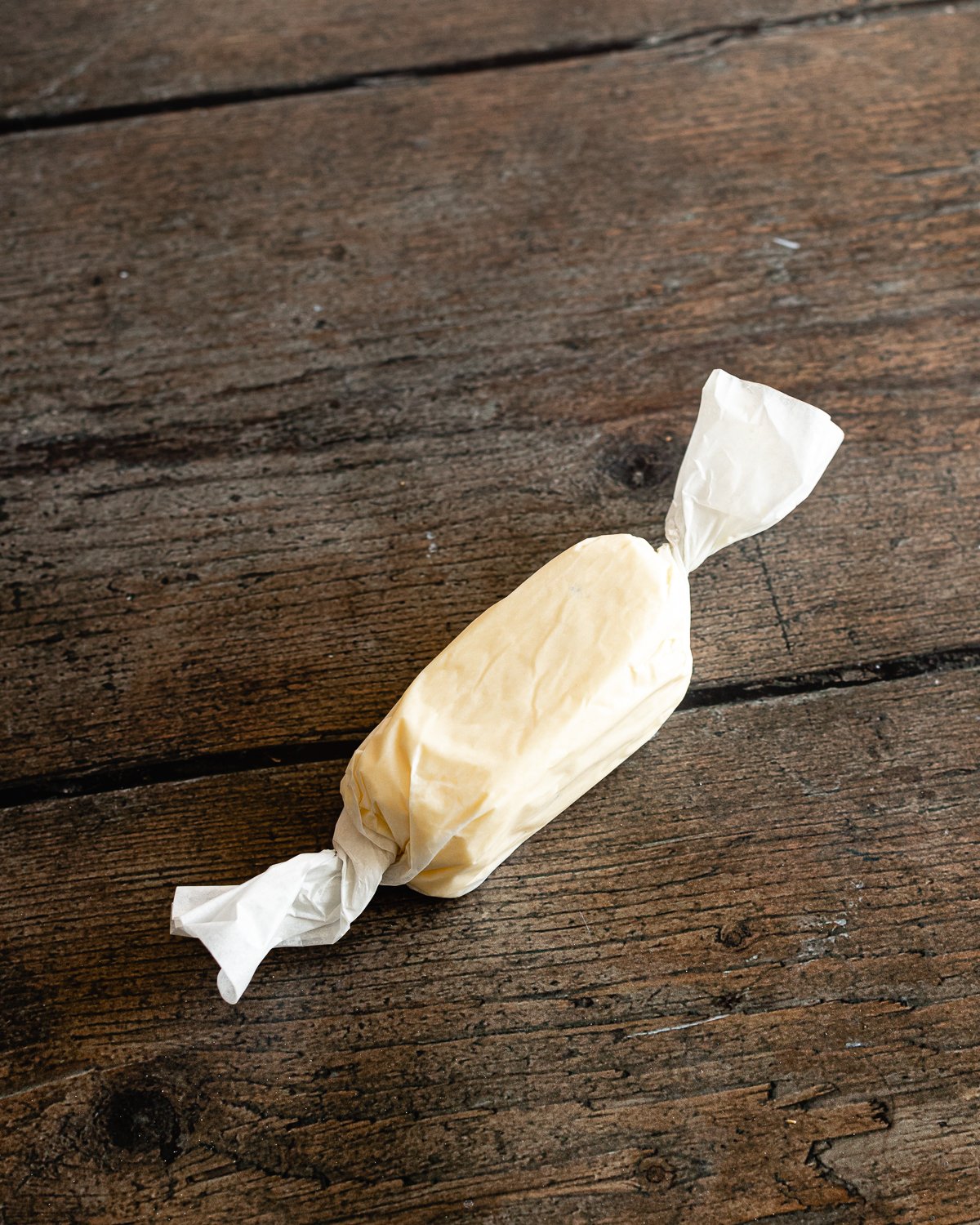 block of butter wrapped in parchment paper