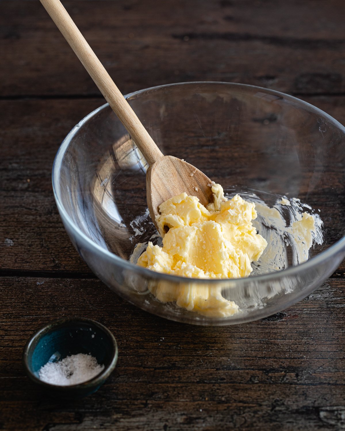 butter in glass bowl with a wooden spoon