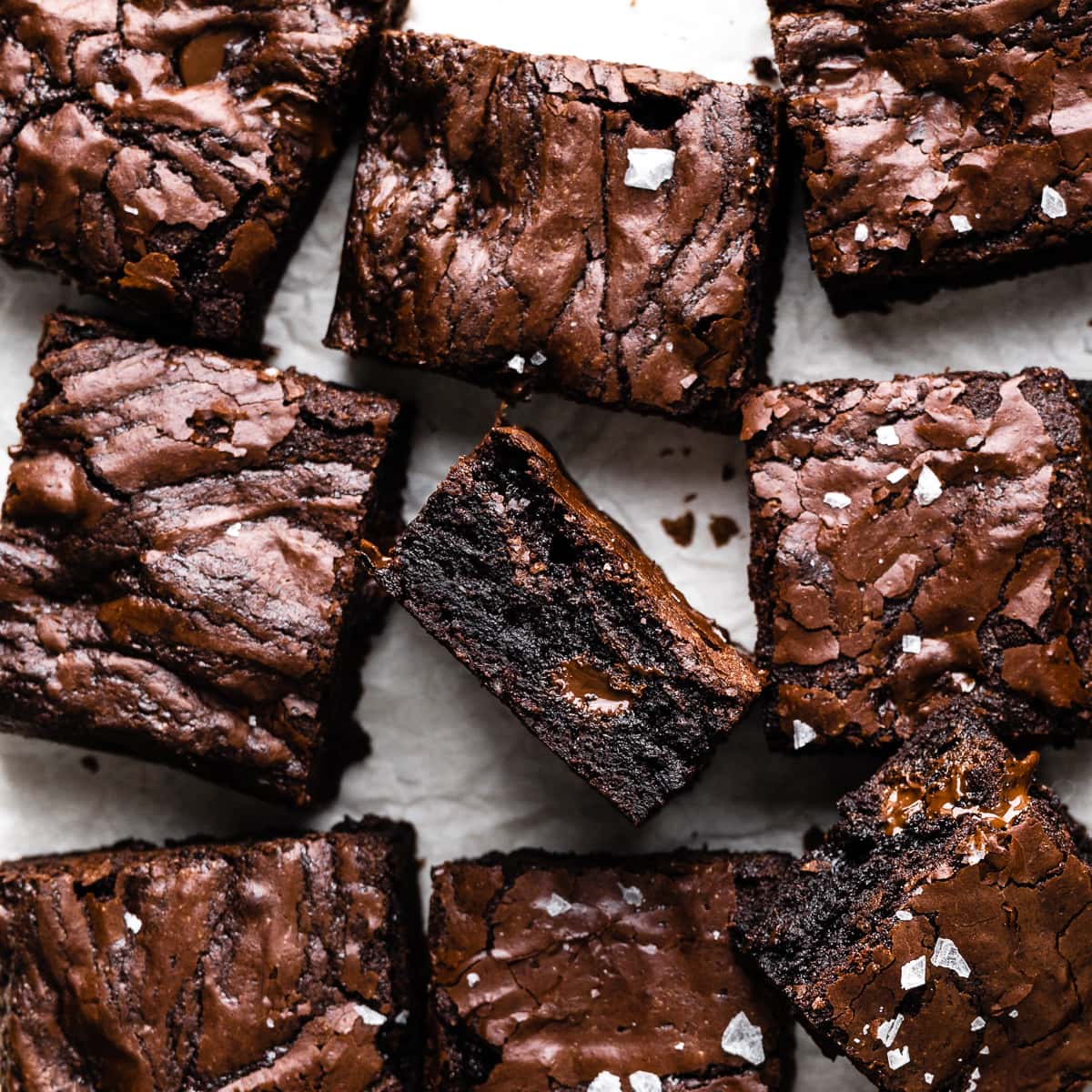 Sliced brownies on parchment paper. 