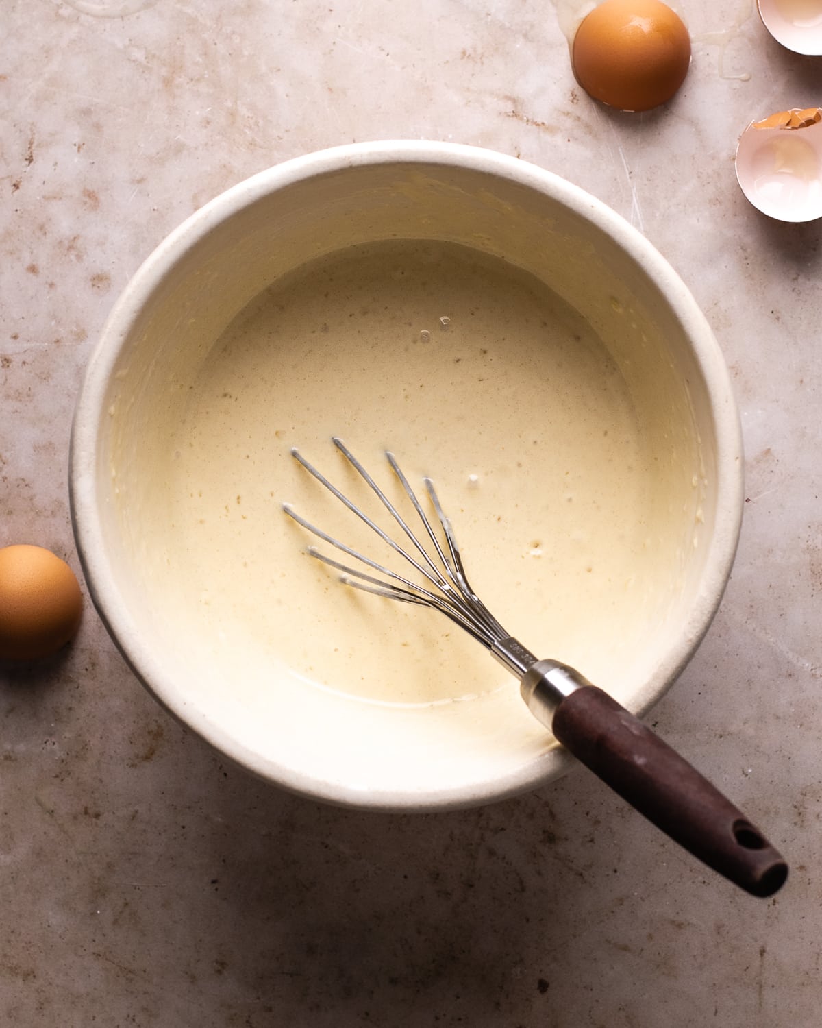 smooth batter with bubbled with a whisk in a white mixing bowl