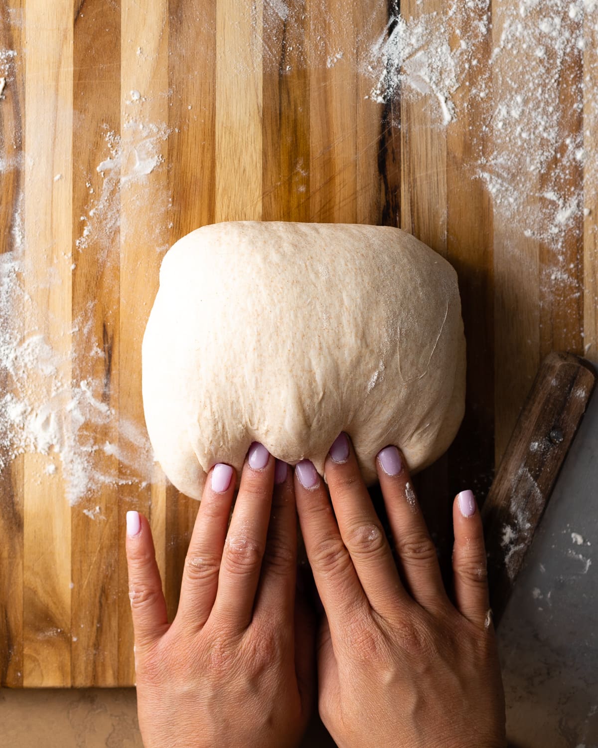 fingers pushing on dough