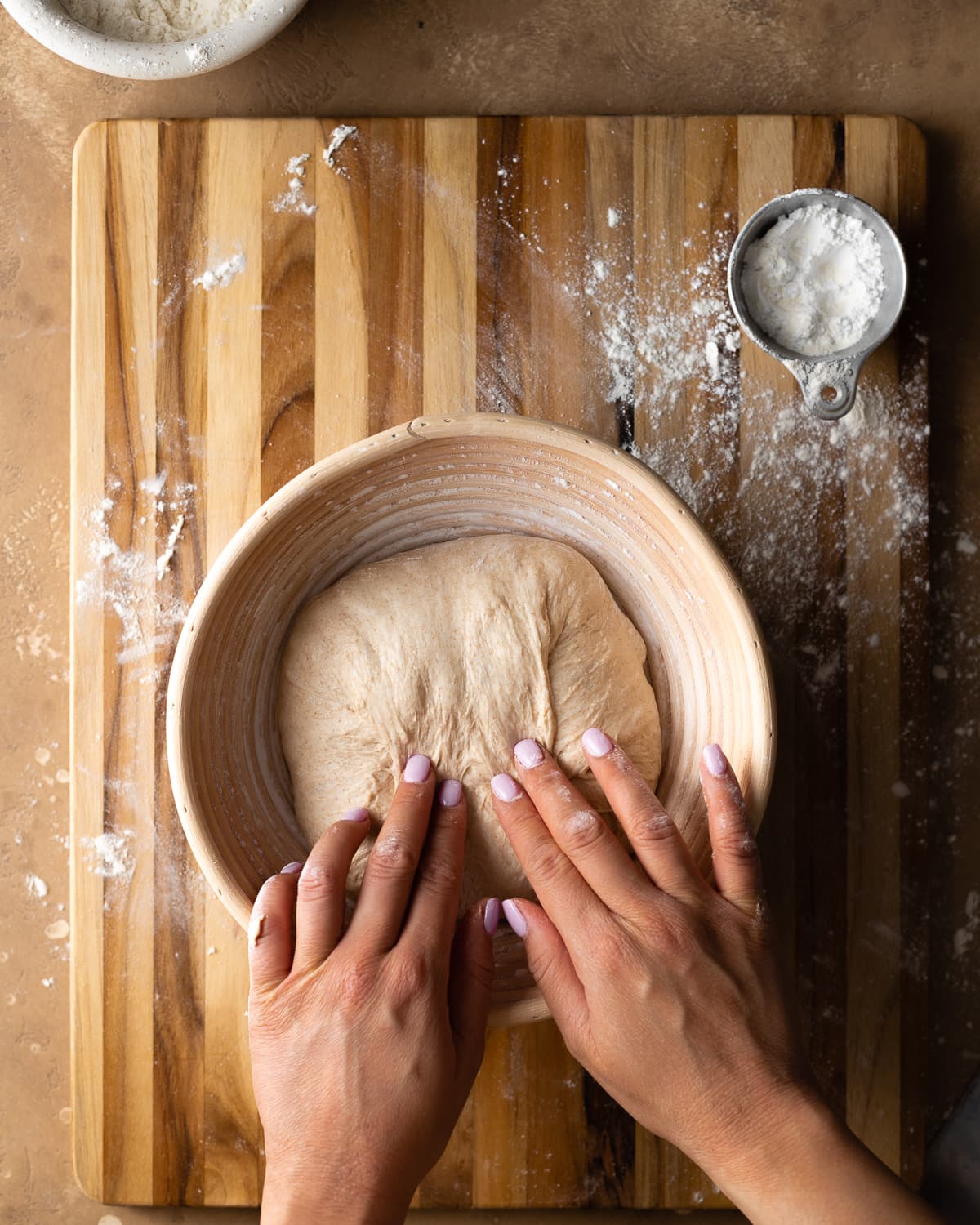 hands stitching dough inside a banneton