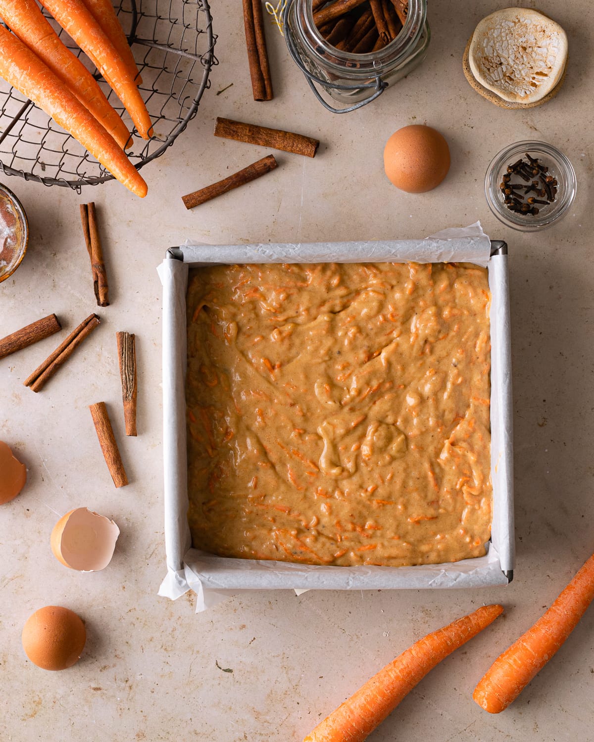 batter in a baking pan lined with parchment