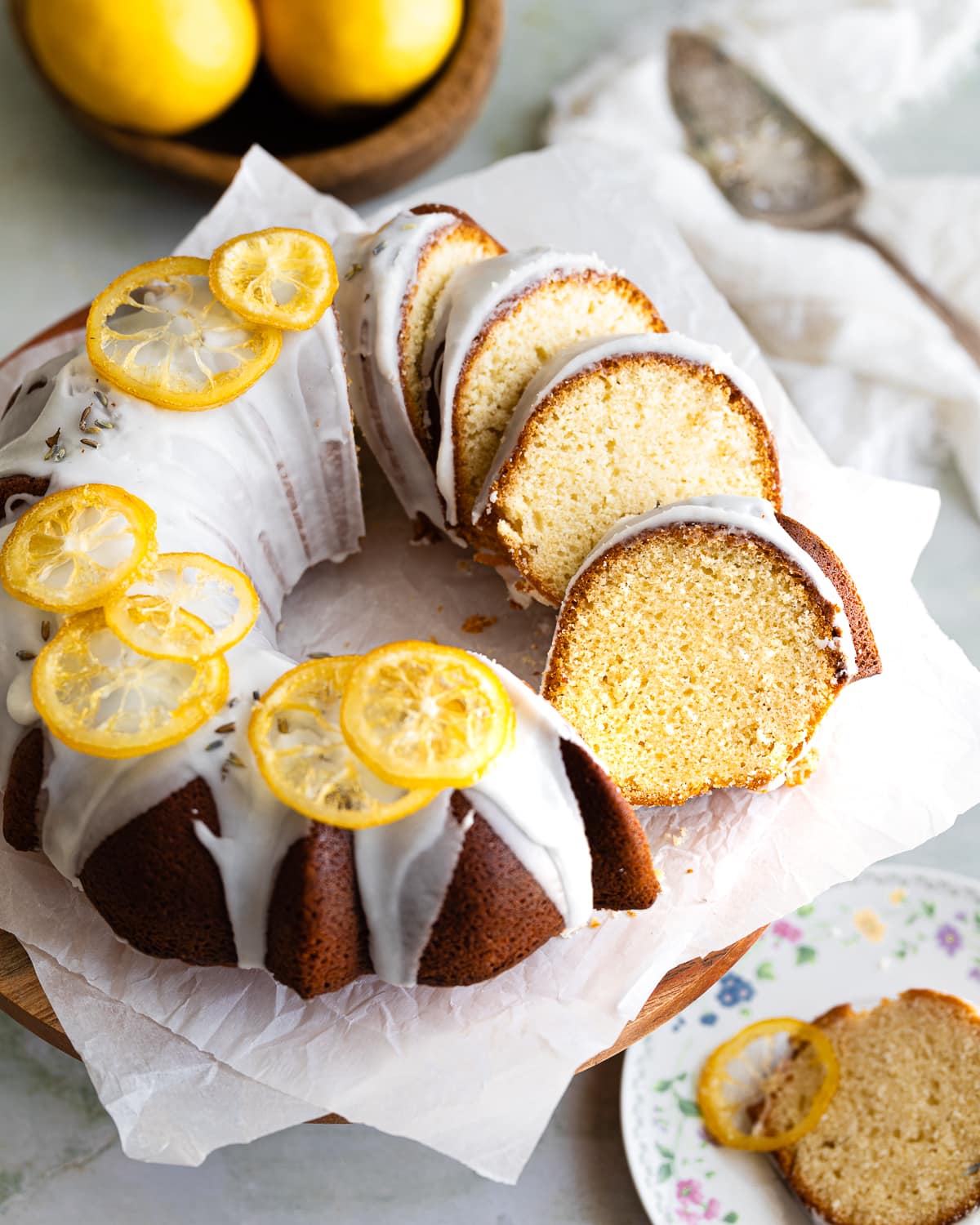 sliced lemon bundt cake on parchment paper