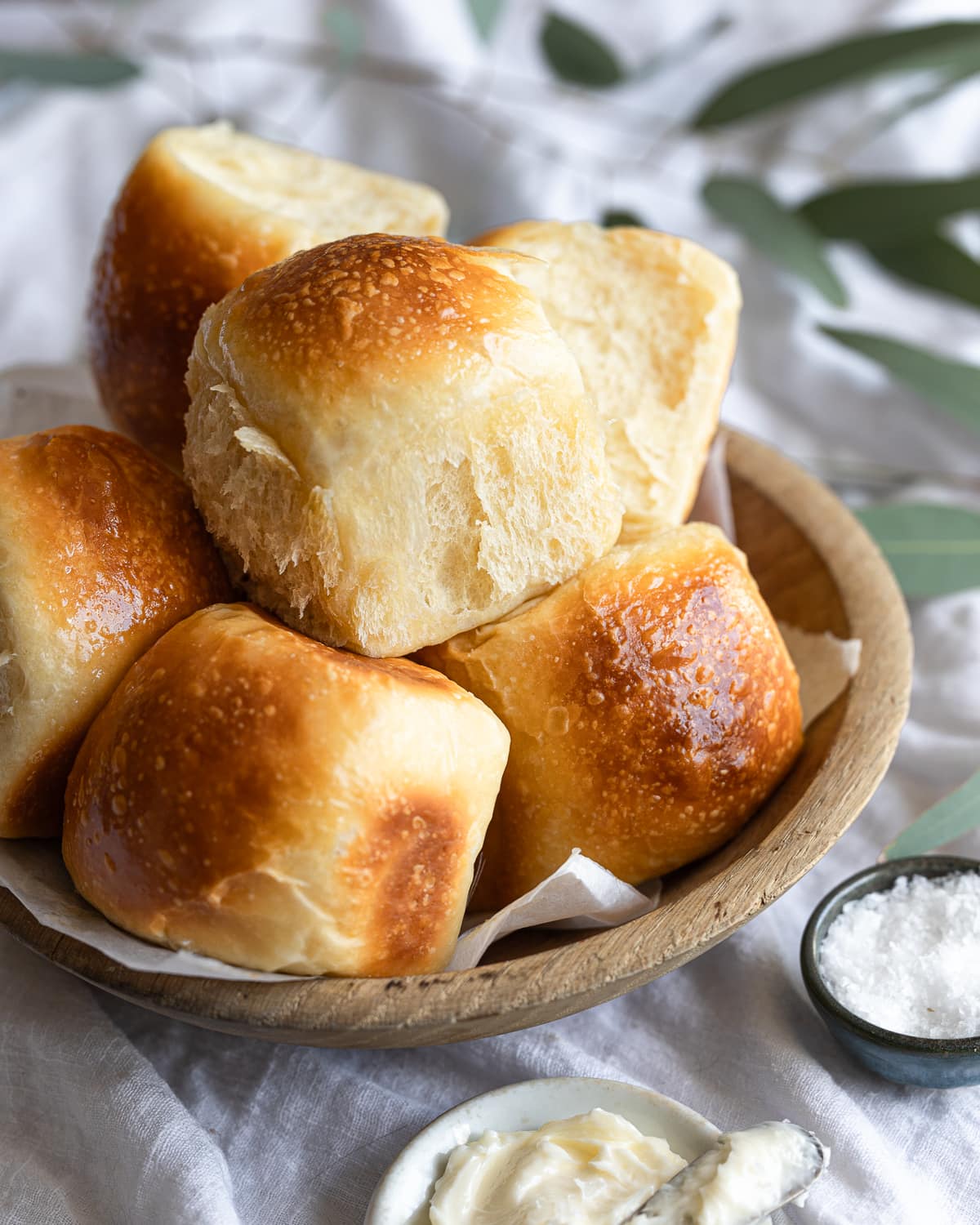 stack of baked rolls in a wooden basket. 