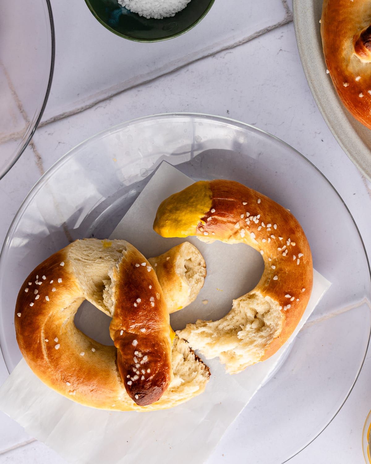 Soft pretzel torn apart on a plate. 