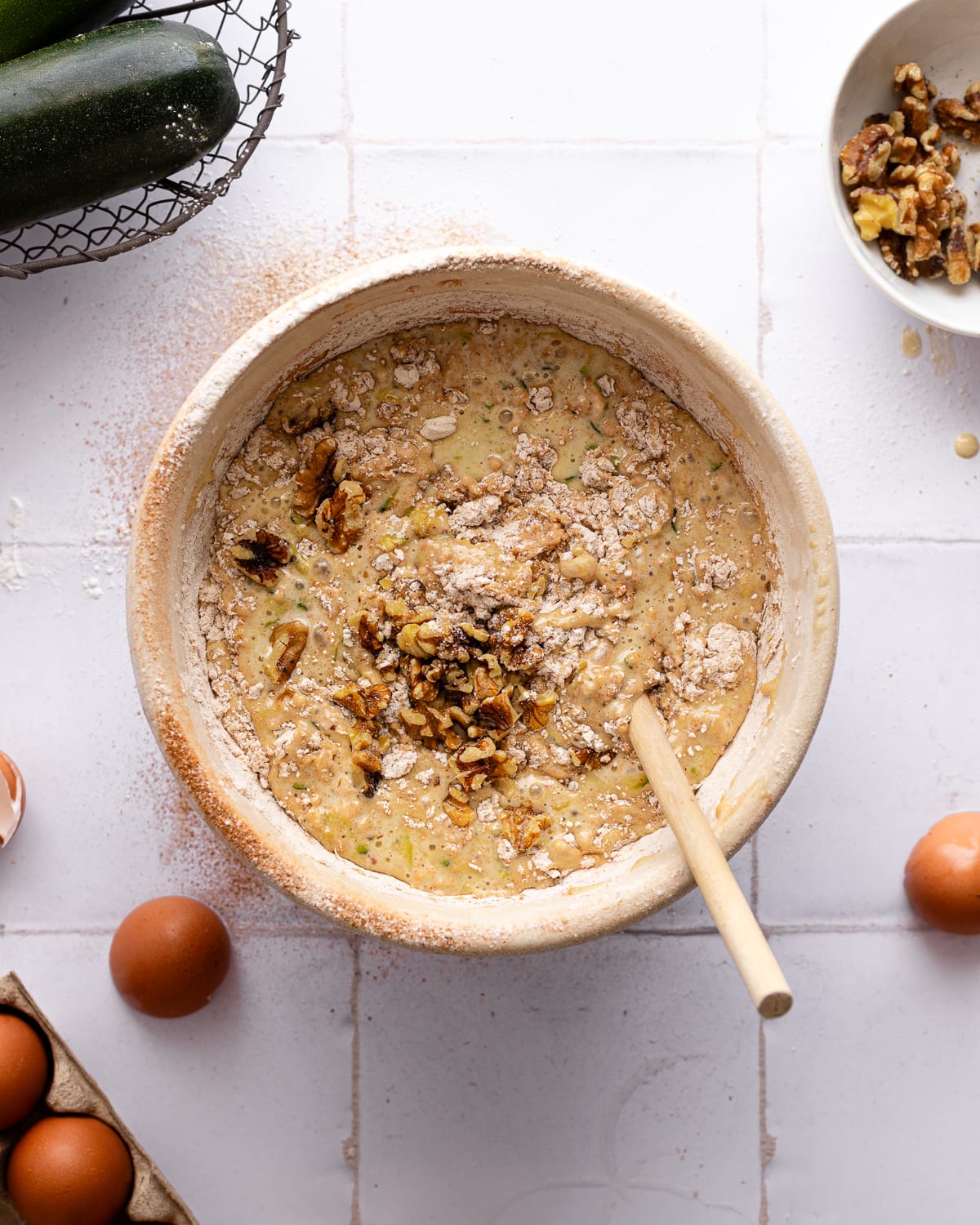 Nuts and flour added to zucchini bread batter. 