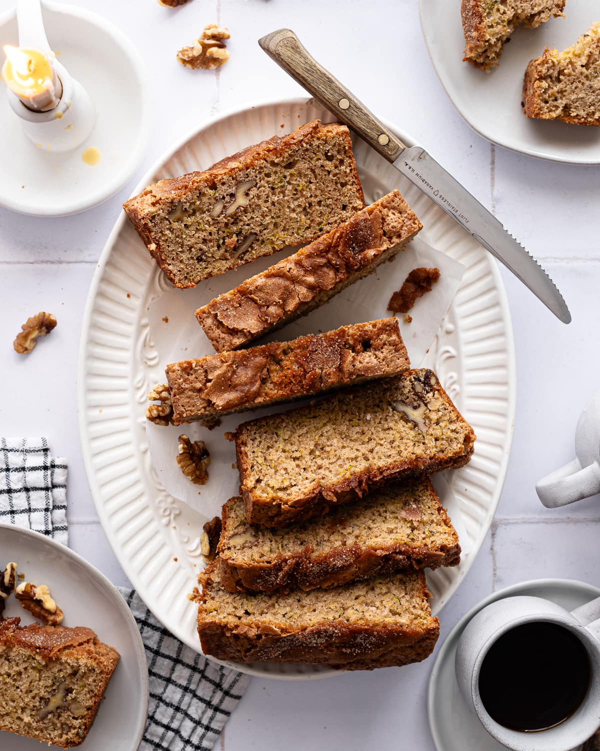 Sliced zucchini bread on a white platter. 