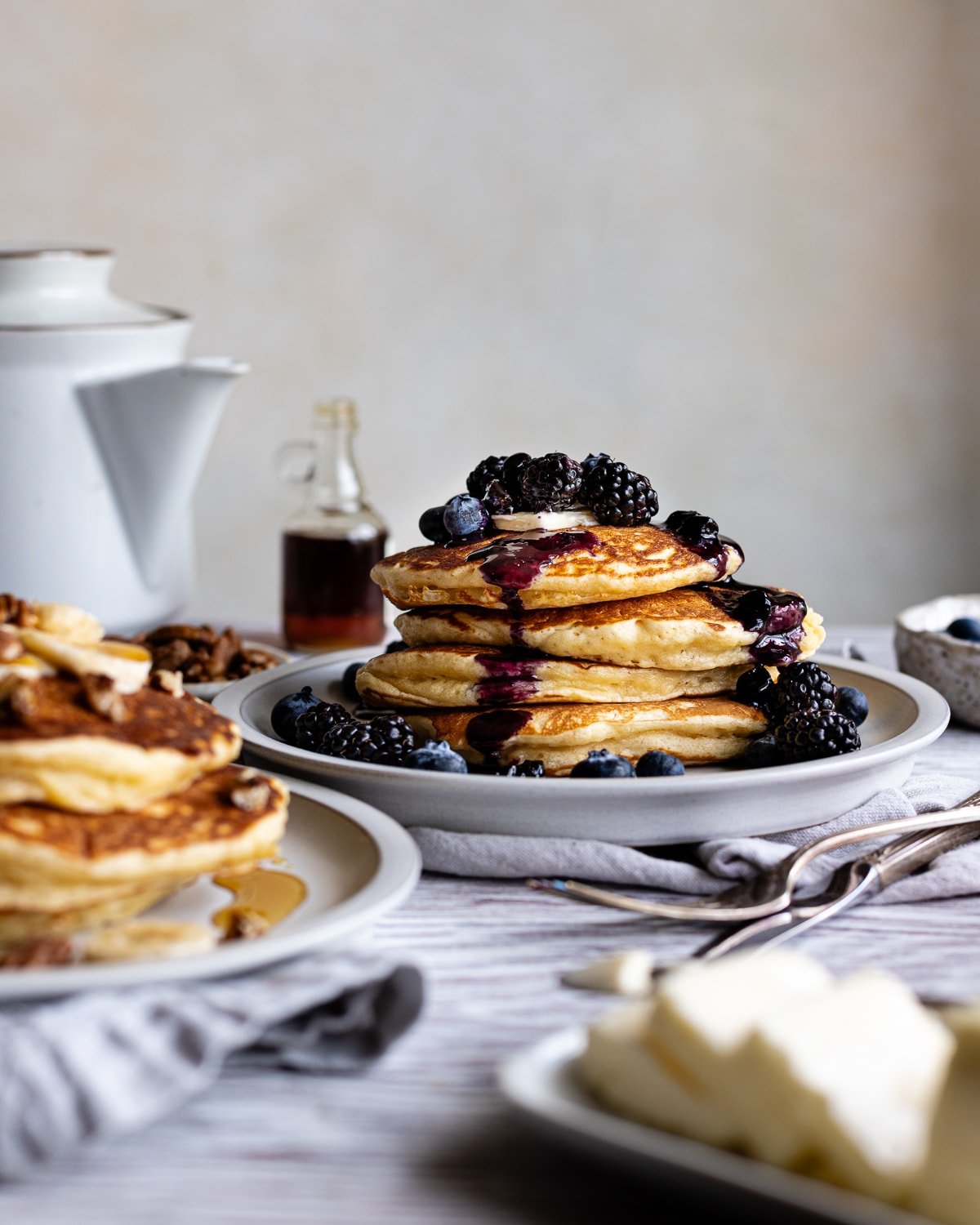 stack of sourdough pancakes topped with berries and berry syrup