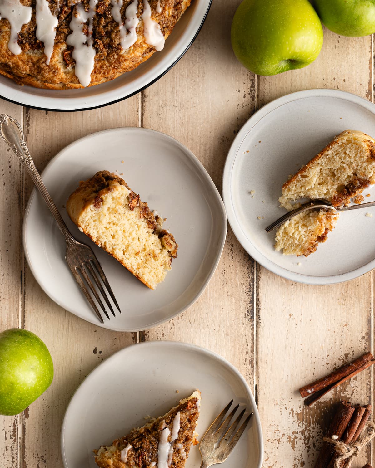 three slices of apple cake on dessert plates.