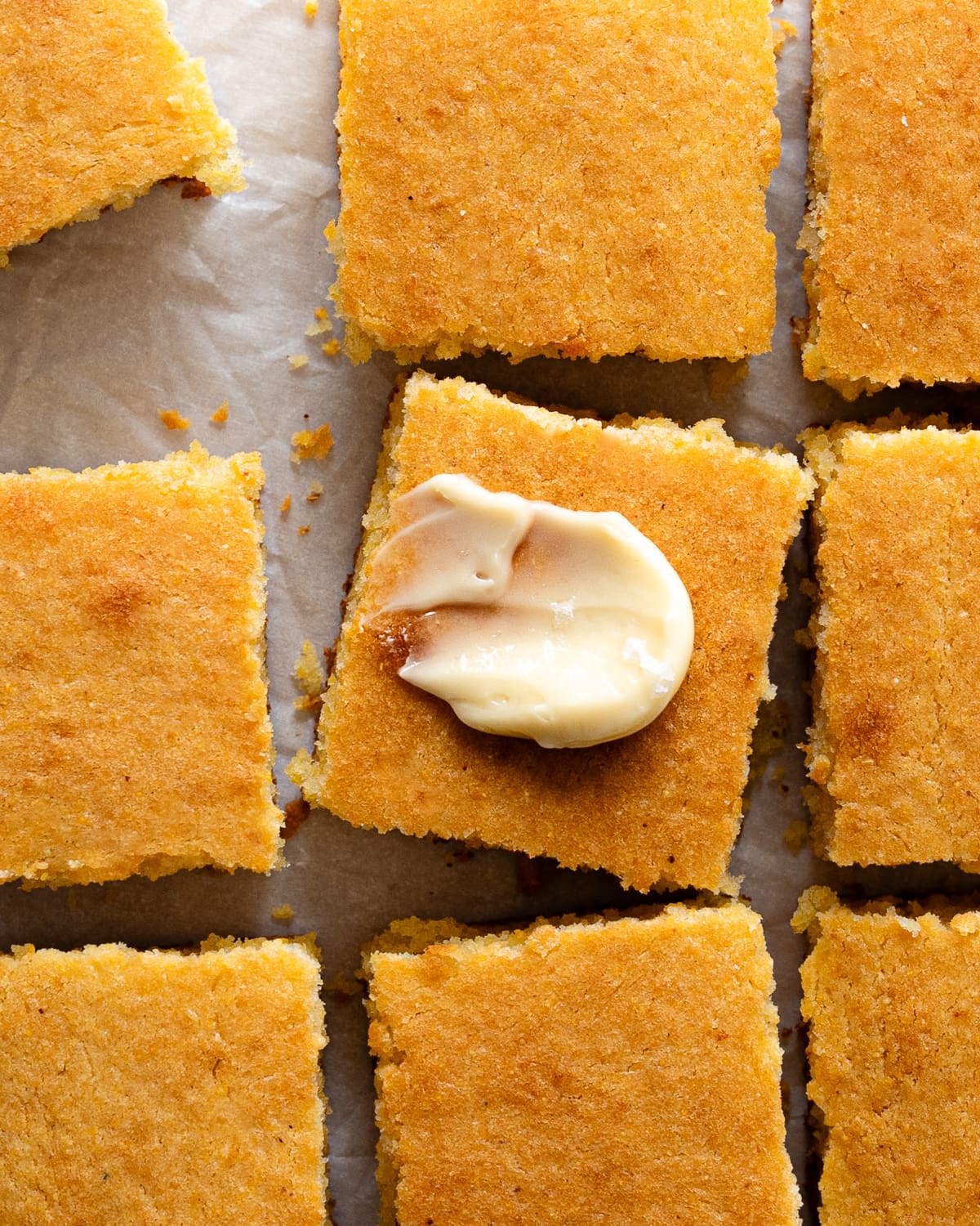 cornbread slices with pat of butter on top.