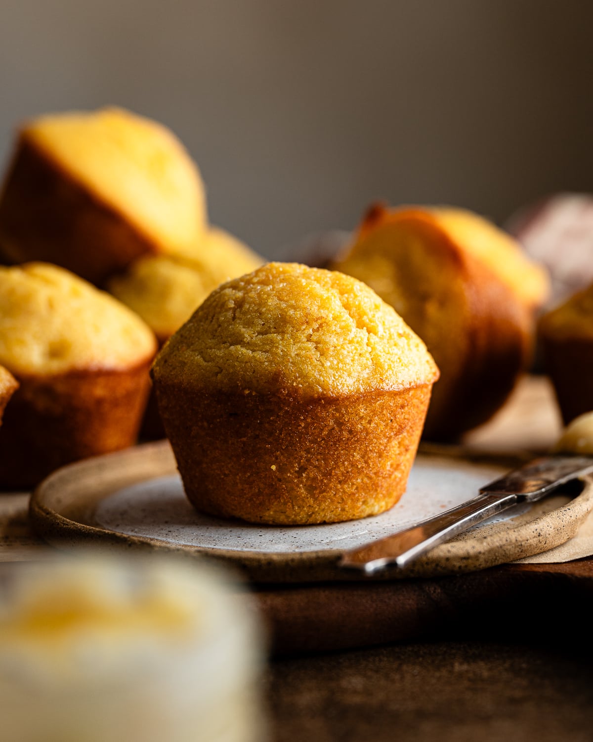 corn muffin with tall muffin top on a plate. 