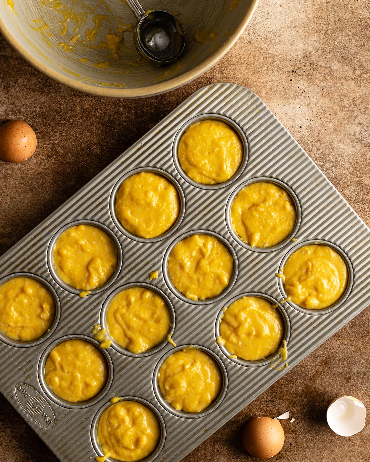 corn muffin batter in muffin tin. 