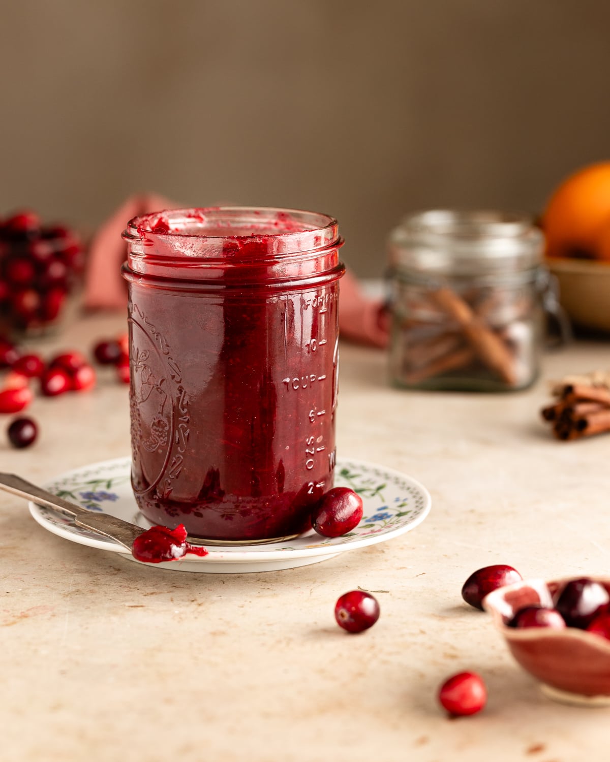 jar of cranberry jam on a small saucer. 