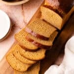 Sliced sweet potato sandwich bread on a wood cutting board.