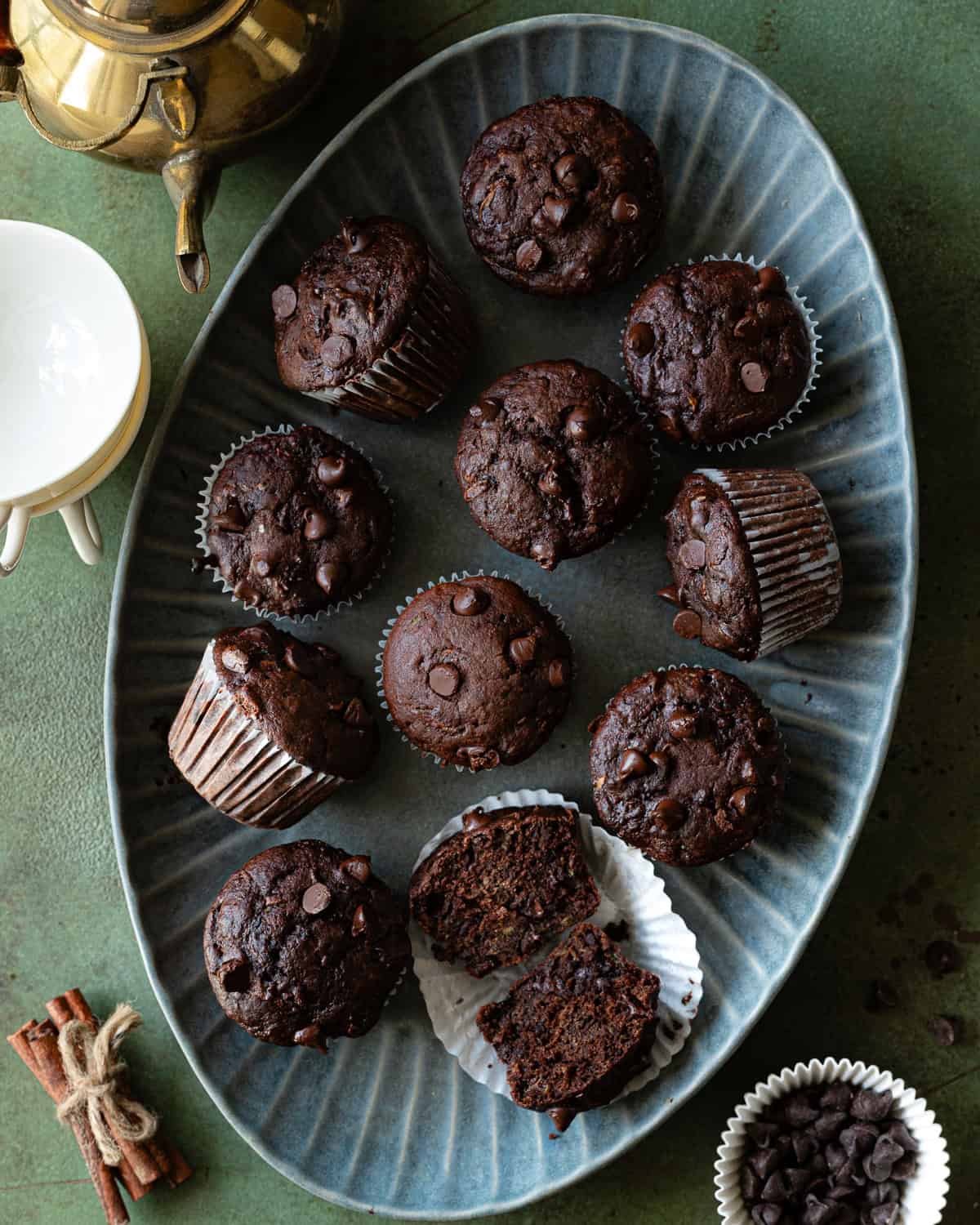 Chocolate muffins on a blue platter. 