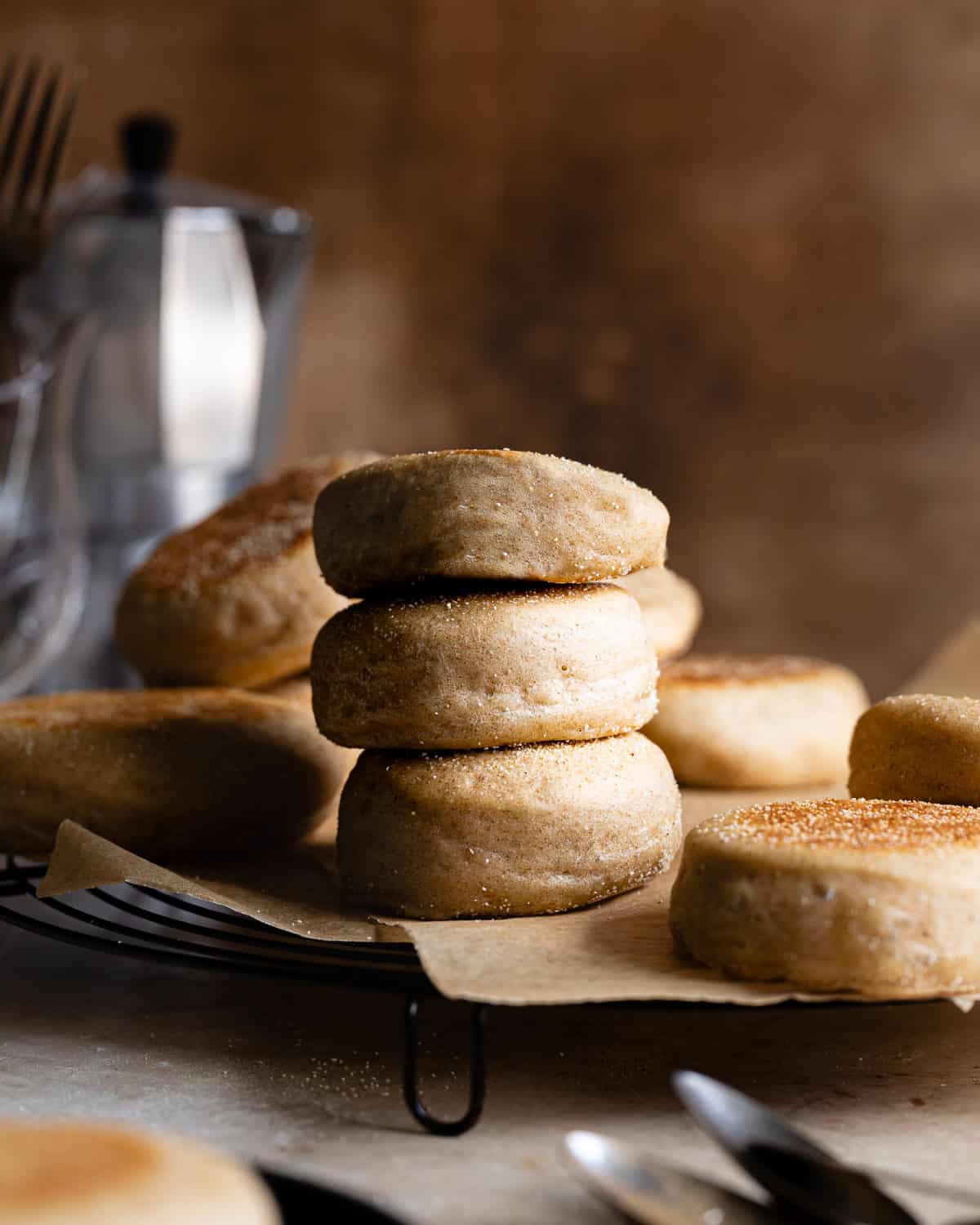 Stack of English muffins on a wire rack. 