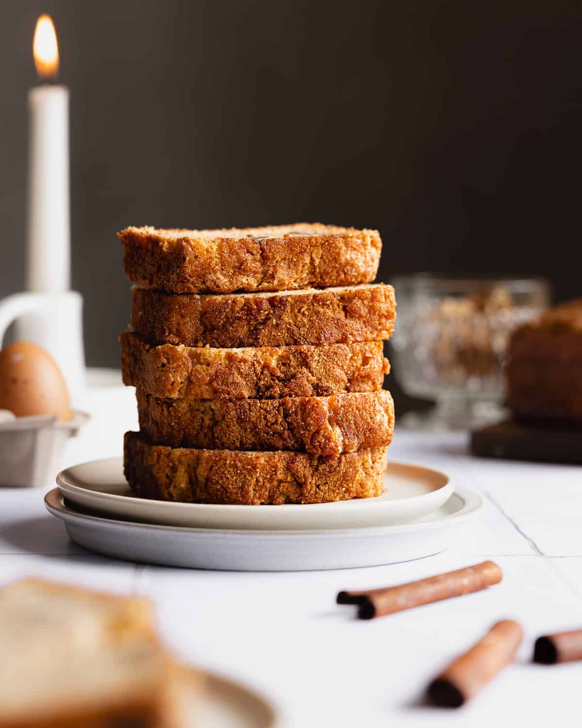 Slices of zucchini bread stacked on a saucer. 