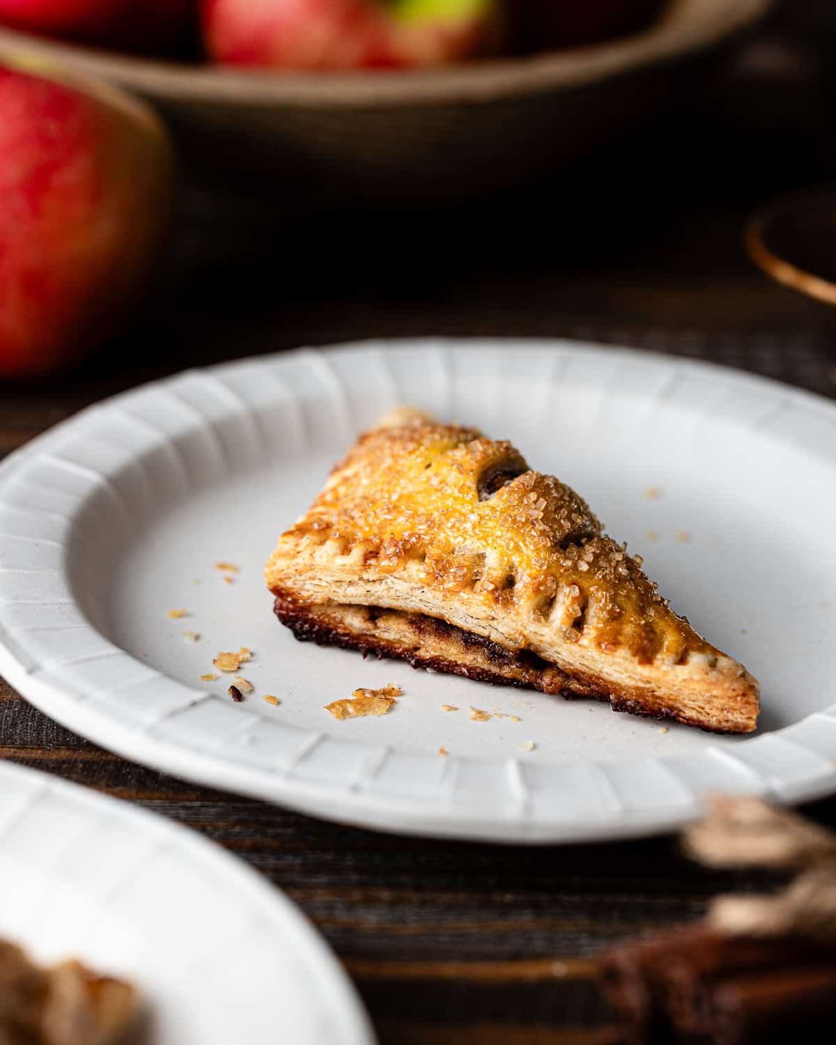 Apple turnover on a ceramic plate.