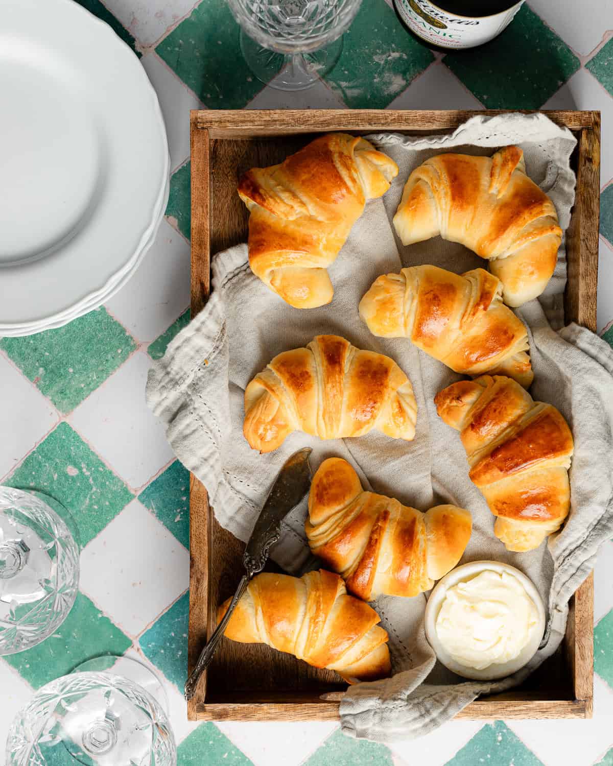 Crescent rolls in a wooden tray.