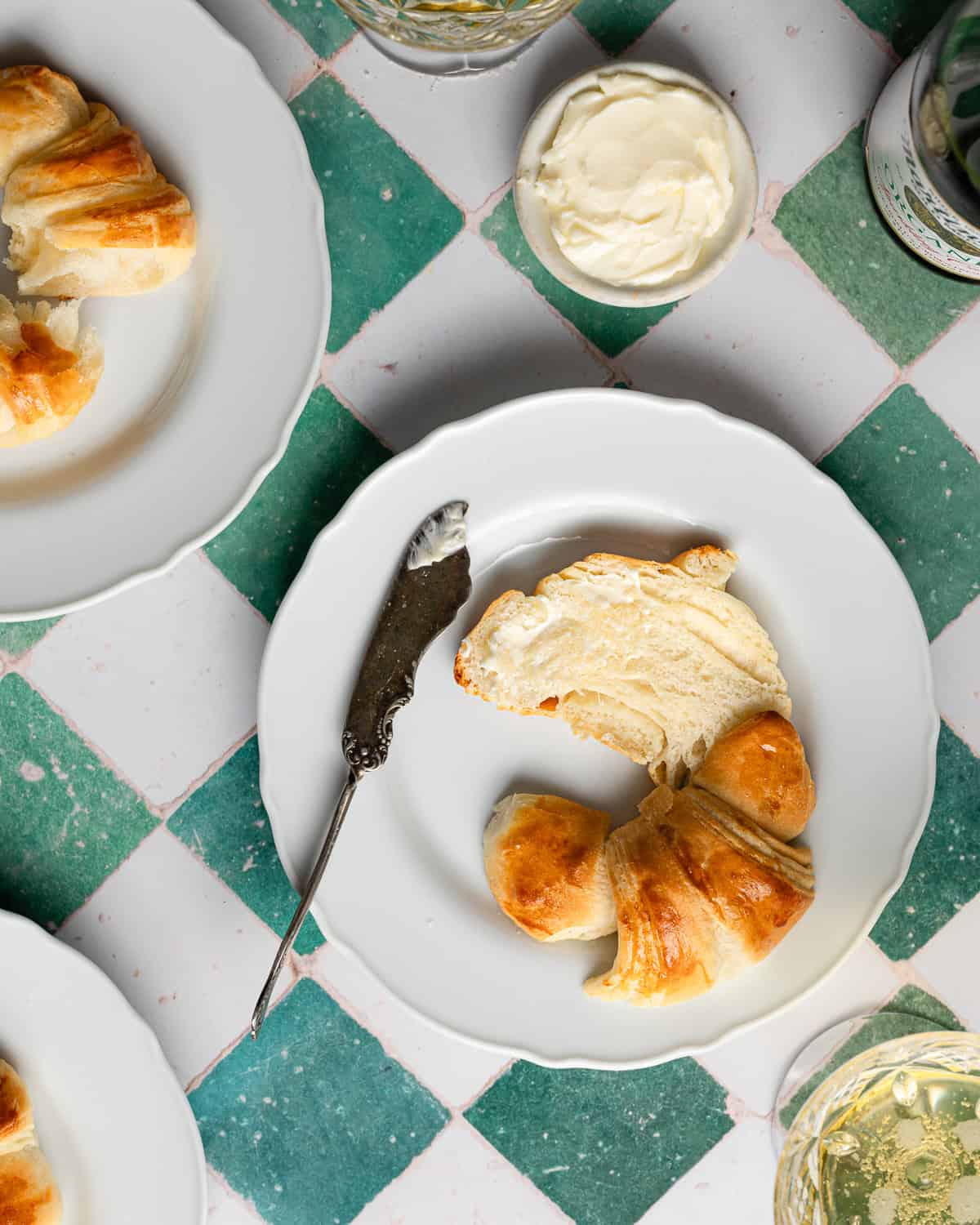 Sliced crescent roll on a white plate.