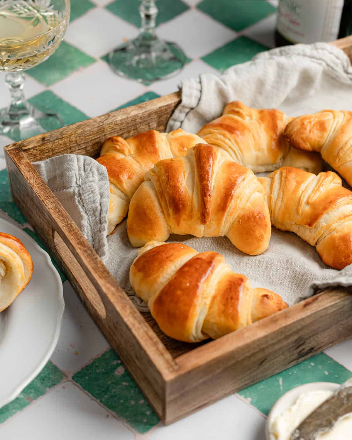 Crescent rolls in a wooden tray.