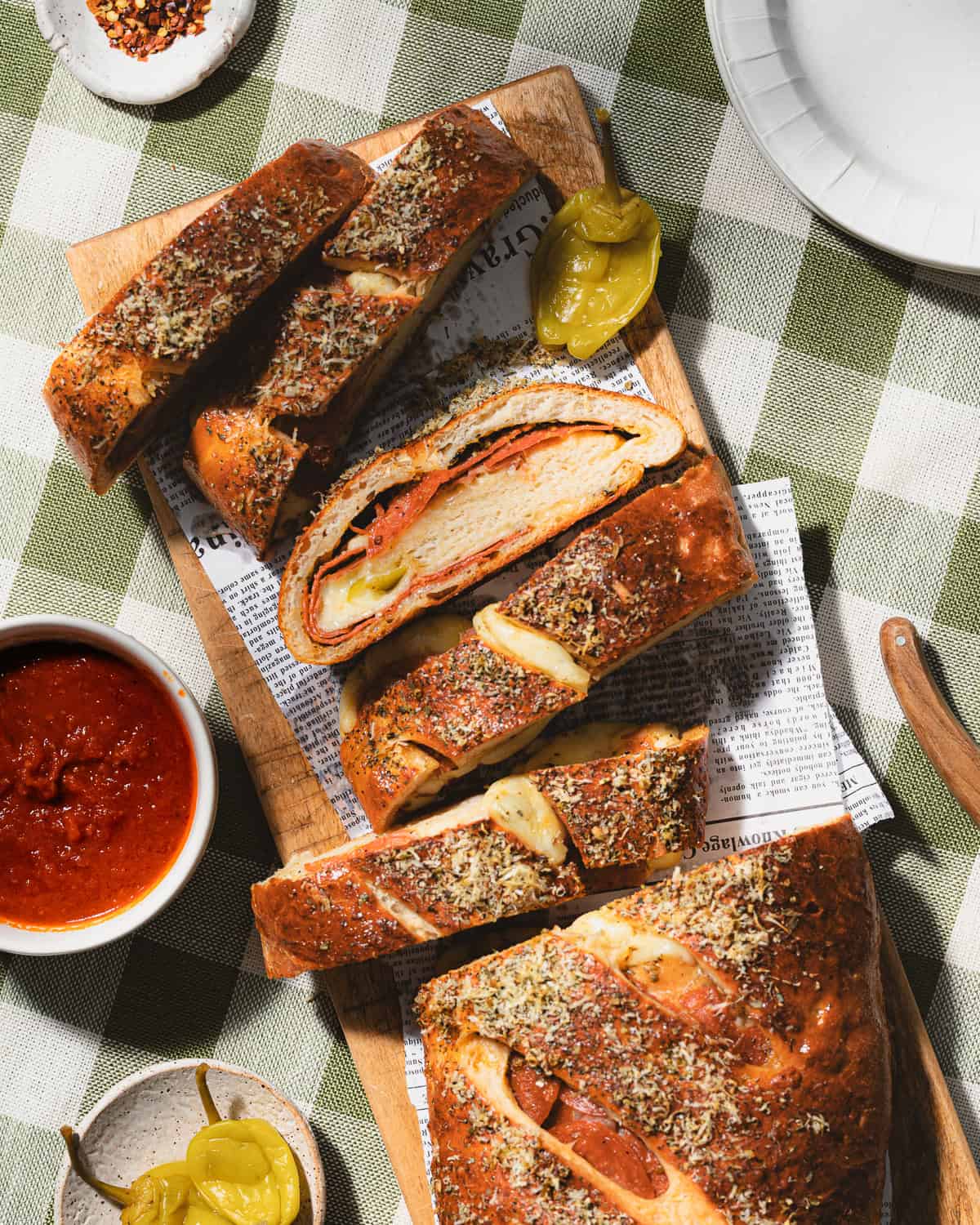 Sliced stromboli on a wooden cutting board. 
