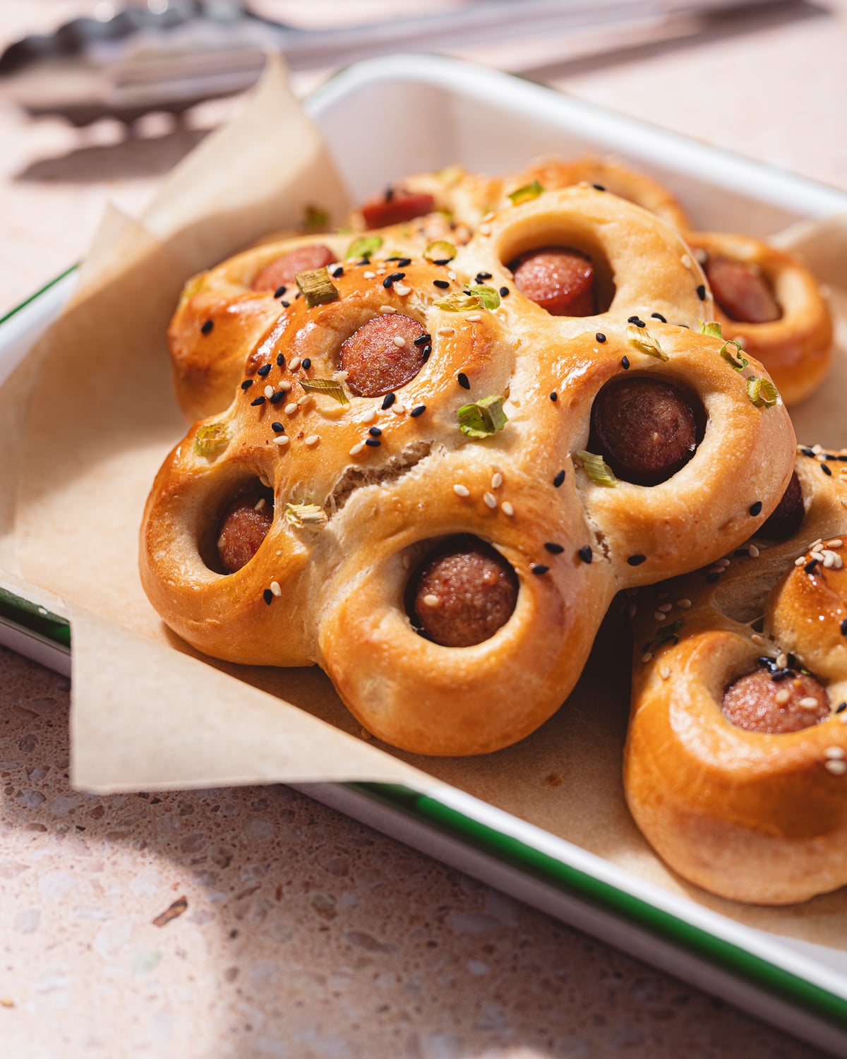 Hot dog flower buns on an enamel tray. 